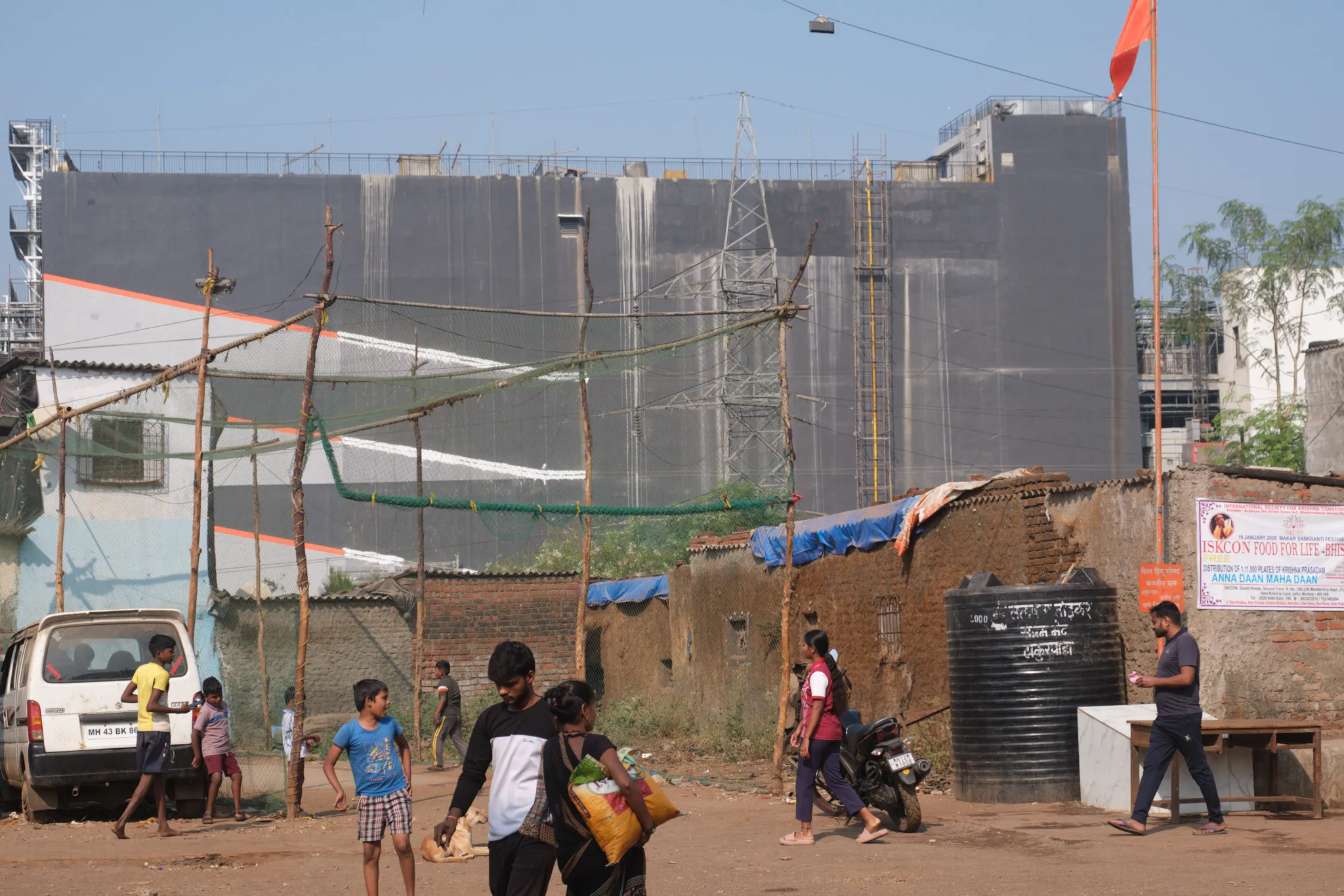 A new seven-story data center by Singapore-based Digital Edge towers over homes in Thakurpada, a low-income neighborhood outside of Mumbai. Photo by Shamsheer Yousaf