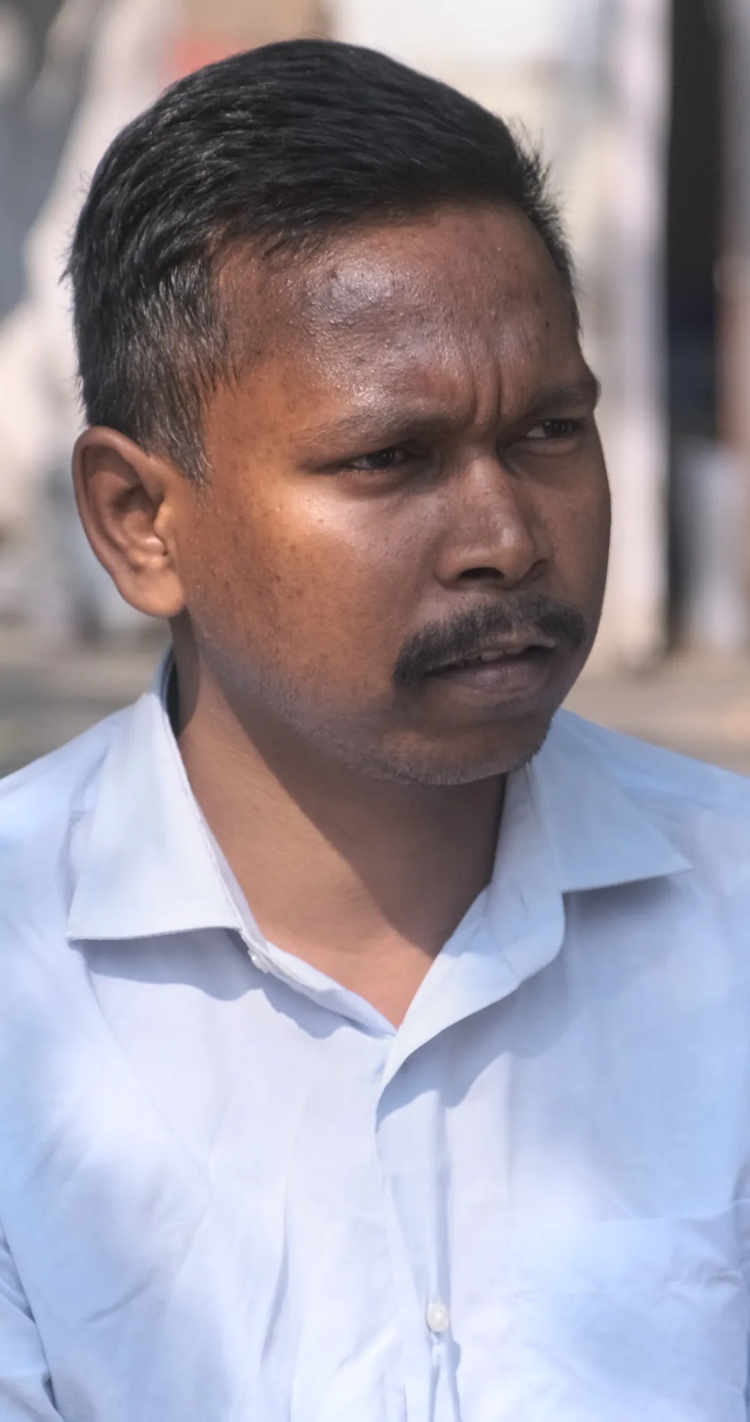 Shiv Sagar, Shrimati Chauhan's son, was beaten and jailed during the eviction and now walks with a limp. He says the developer sends men to intimidate residents at the resettlement site.